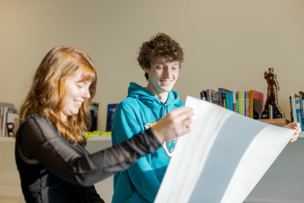 Studenten S2B zijn bezig met een poster te drukken.