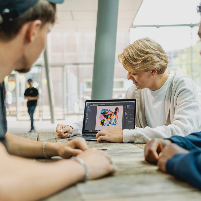 Studenten bekijken het werk van een mede student